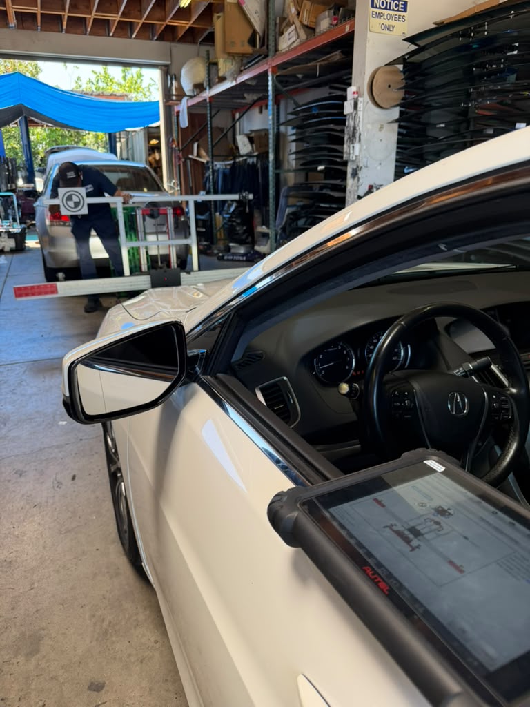 Acura with door open and Autel tablet mounted during calibration
